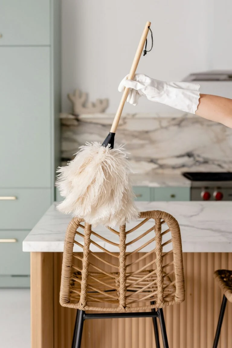 Cleaner in white gloves cleaning a chair