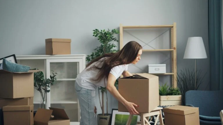 Moving boxes in a living room before a move-in clean