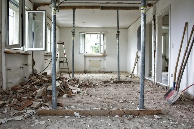 Room under renovation with dust and debris on the floor
