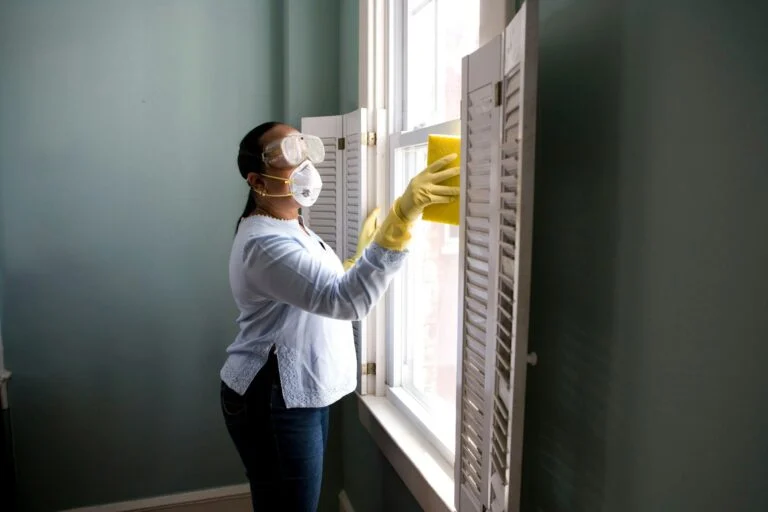 Cleaner tidying a bright room